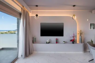 a living room with a flat screen tv on a wall at Armdin Seaview Villa 1 in Módhion