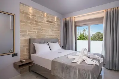 a bedroom with a bed with a towel on it at Armdin Seaview Villa 1 in Módhion