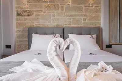 a bed with two swans towels on it at Armdin Seaview Villa 1 in Módhion