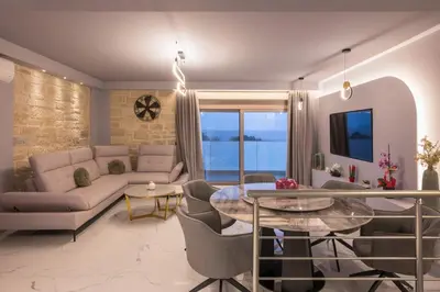 a living room with a couch and a table at Armdin Seaview Villa 2 in Módhion