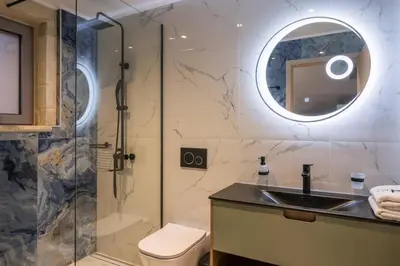 a bathroom with a shower and a sink and a toilet at Armdin Seaview Villa 2 in Módhion