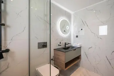 a bathroom with a toilet and a sink and a shower at Armdin Seaview Villa 2 in Módhion