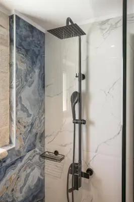 a shower with a glass door in a bathroom at Armdin Seaview Villa 3 in Módhion