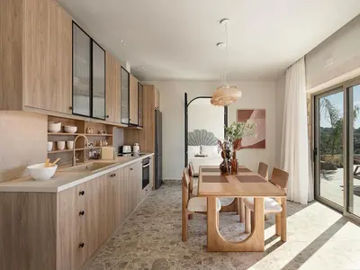 a kitchen with a wooden table and a dining room at Casa Viento in Ravdhoúkha