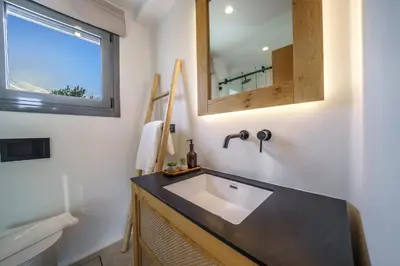 a bathroom with a sink and a mirror at EAST VILLA by CYAMES in Gavalochori
