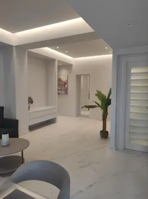 a living room with white walls and a ceiling at MELINA CITY Apartments in Chania Town