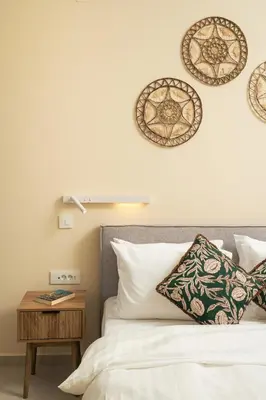 a bedroom with a bed and a nightstand and plates on the wall at BelSodi - 3bedroom sea views and heated pool in Chania Town
