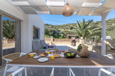 a dining room with a table with food on it at Victoria Luxury Residence in Kissamos