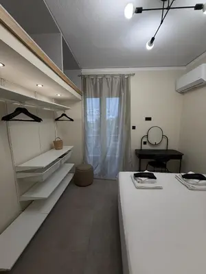 a room with two beds and a window at NESTIVA - Apartment in the Center of Chania in Chania Town
