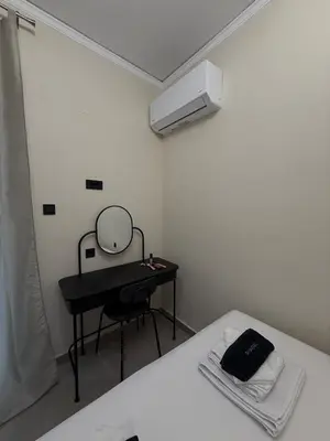 a bedroom with a bed with a mirror and a dressing table at NESTIVA - Apartment in the Center of Chania in Chania Town