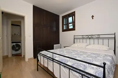 a bedroom with a bed and a washing machine at Chania Hillside 2BD Home - Nature & Comfort by ΜΡS