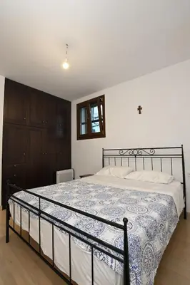 a bedroom with a bed with a blue and white comforter at Chania Hillside 2BD Home - Nature & Comfort by ΜΡS