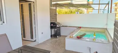a hot tub in the middle of a living room with a table at Cozy Apartment with Private Jacuzzi - Fiber Internet - Private Parking in Chania Town