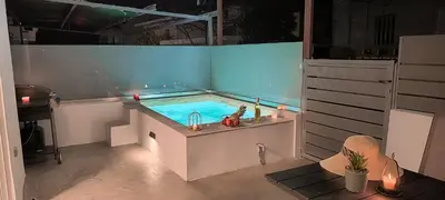 a swimming pool with a tub in a room at Cozy Apartment with Private Jacuzzi - Fiber Internet - Private Parking in Chania Town