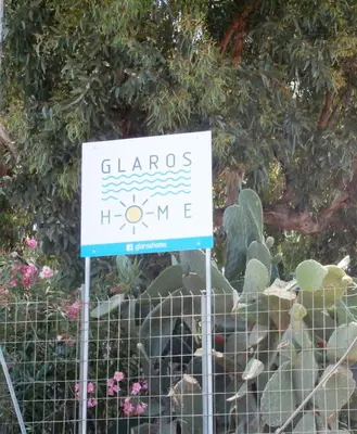 a sign in front of a fence with cactus at Glaros Home in Kato Daratso