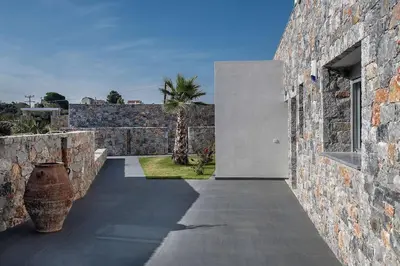 a stone building with a door and a courtyard at Aloni Villa with pool Kefalas in Vamos