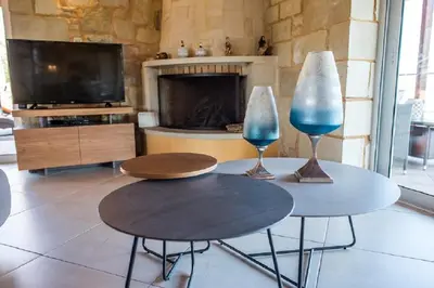 two tables in a living room with a fireplace at Villa Chara Chania in Agia Marina Nea Kydonias