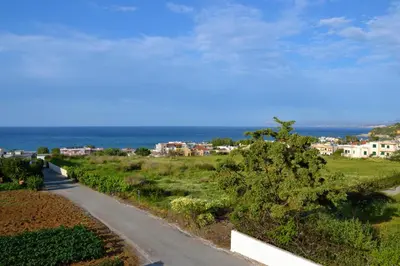 a road leading down to a beach with the ocean at Sofoklis Apts in Stalos