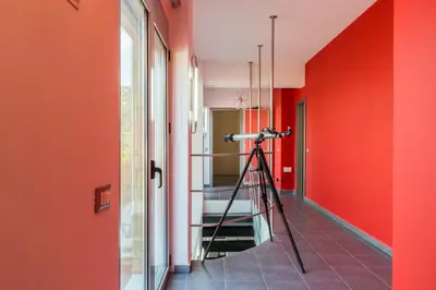 a camera on a tripod in a room with red walls at Villa Casa di Verde in Patellárion