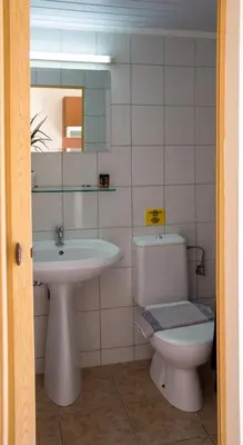 a bathroom with a toilet and a sink and a mirror at Iason Studios in Chania Town
