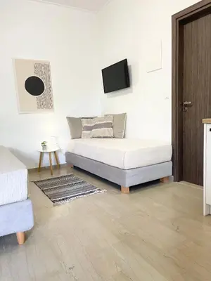 a bedroom with a bed and a tv on a wall at Katerina Sea Apartments in Chania Town