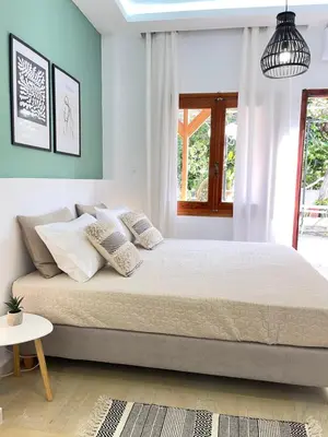 a bedroom with a large bed with white pillows at Katerina Sea Apartments in Chania Town