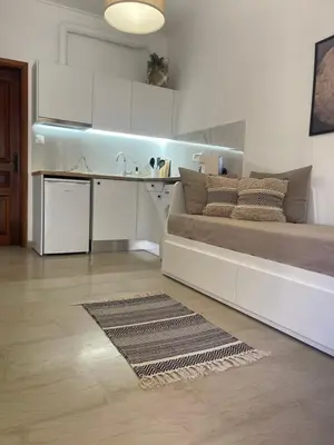 a living room with a bed and a kitchen at Katerina Sea Apartments in Chania Town