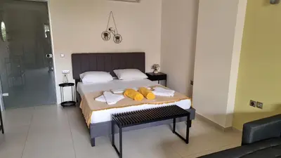 a bedroom with a bed with towels on it at Sandy Point Villas Chania in Agia Marina Nea Kydonias