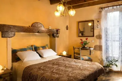 a bedroom with a large bed and a mirror at Villa Margot in Chania Town
