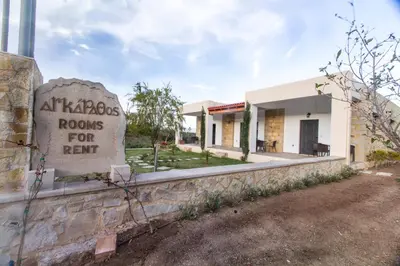 a building with a sign that reads rooms for rent at Agarathos Tradiitonal Apartments & Rooms with Pool Kaliviani -On the road to Balos in Kissamos