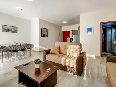 a living room with a couch and a table at Studio in Ravdoucha with Sea View Balcony in Ravdhoúkha