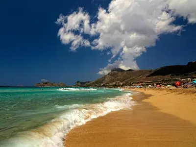 a beach with the ocean and people on it at Studio in Ravdoucha with Sea View Balcony in Ravdhoúkha