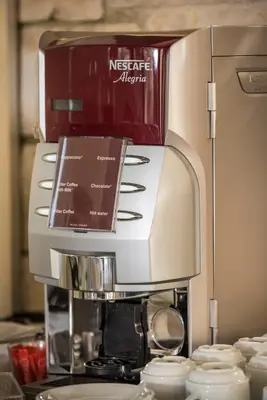 a coffee machine with a box on top of it at Minos Village in Agia Marina Nea Kydonias