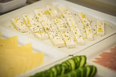 a bunch of cheese and other foods on a table at Minos Village in Agia Marina Nea Kydonias
