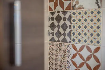 a wall with a bunch of different patterns on it at Traditional Sea Side Cottage in Maleme