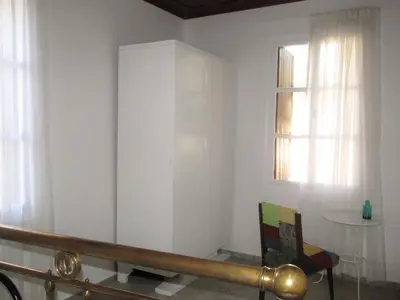 a white room with a chair and a window at Trouli House in Stalos