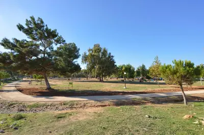 a path in a park with trees and grass at Katerina Rooms Agii Apostoloi in Kato Daratso