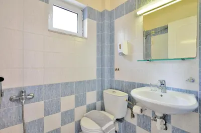 a bathroom with a toilet and a sink at Katerina Rooms Agii Apostoloi in Kato Daratso