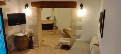 a living room with a fireplace and a tv at Filippou Villa - Living in Nature in Fílippos