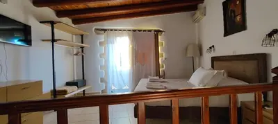 a bedroom with a bed and a window at Filippou Villa - Living in Nature in Fílippos