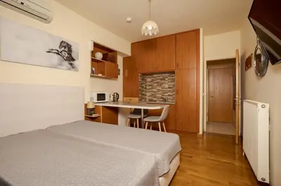 a small bedroom with a bed and a kitchen at Panoramic Sea View in Chania Town