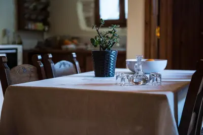 a table with a white table cloth and a vase on it at Antheia Houses in Vamos