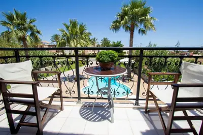 a patio table with a potted plant on a balcony at Erodios Villas 1 in Gerani Chanion