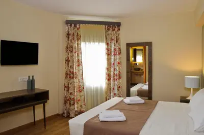 a bedroom with a bed and a window with towels on it at Elia Kentron in Chania Town