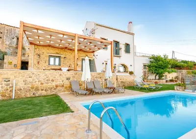 a villa with a swimming pool and a house at Villa Panareti in Kolymvari