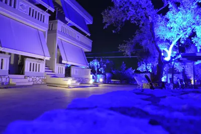 a building with purple and blue lights at night at Harmony Apartments in Kato Daratso