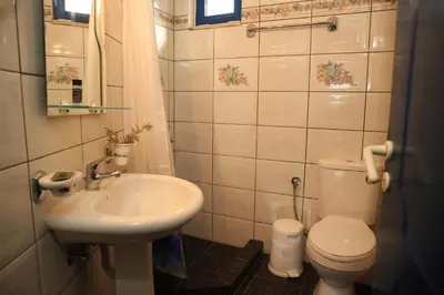 a small bathroom with a sink and a toilet at Mantilida Villa & Studio in Kissamos
