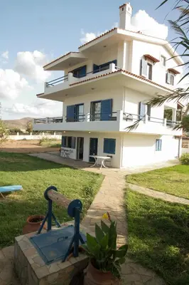 a large white house with a building at Mantilida Villa & Studio in Kissamos
