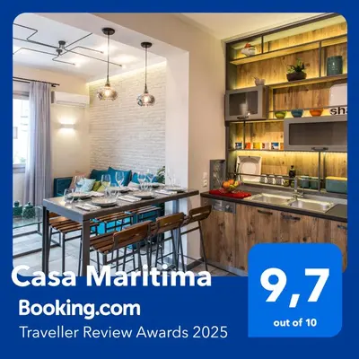 a kitchen with wooden cabinets and a table with chairs at Casa Maritima in Chania Town