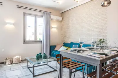 a dining room with a table and a couch at Casa Maritima in Chania Town